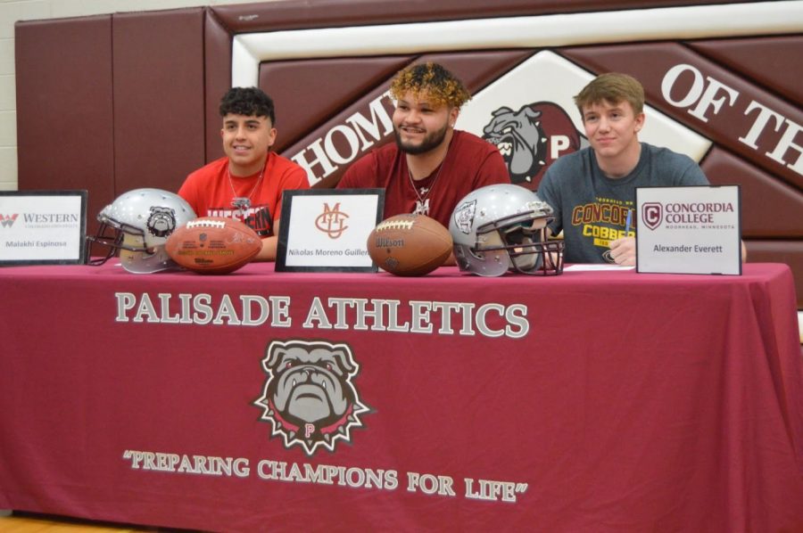 Malakhi Espinosa (Left), Niko Moreno(Middle), and Alexander Everett (Right) sitting at their signing table. 
