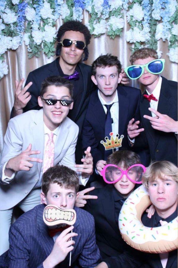 Group of boys pose for the photo booth at the dance.