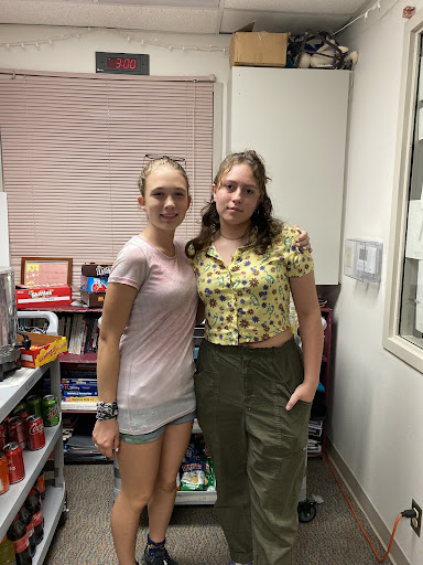 Picture of Emma Clark and Aspen Johnson members of the FBLA club in front of their snack cart. 
