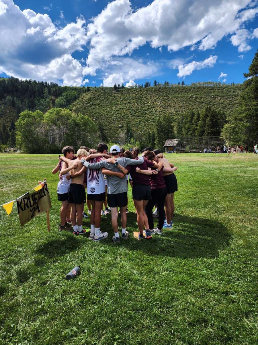 Cross-Country teams huddle before race 
Photo Provided by: Hank Deford 