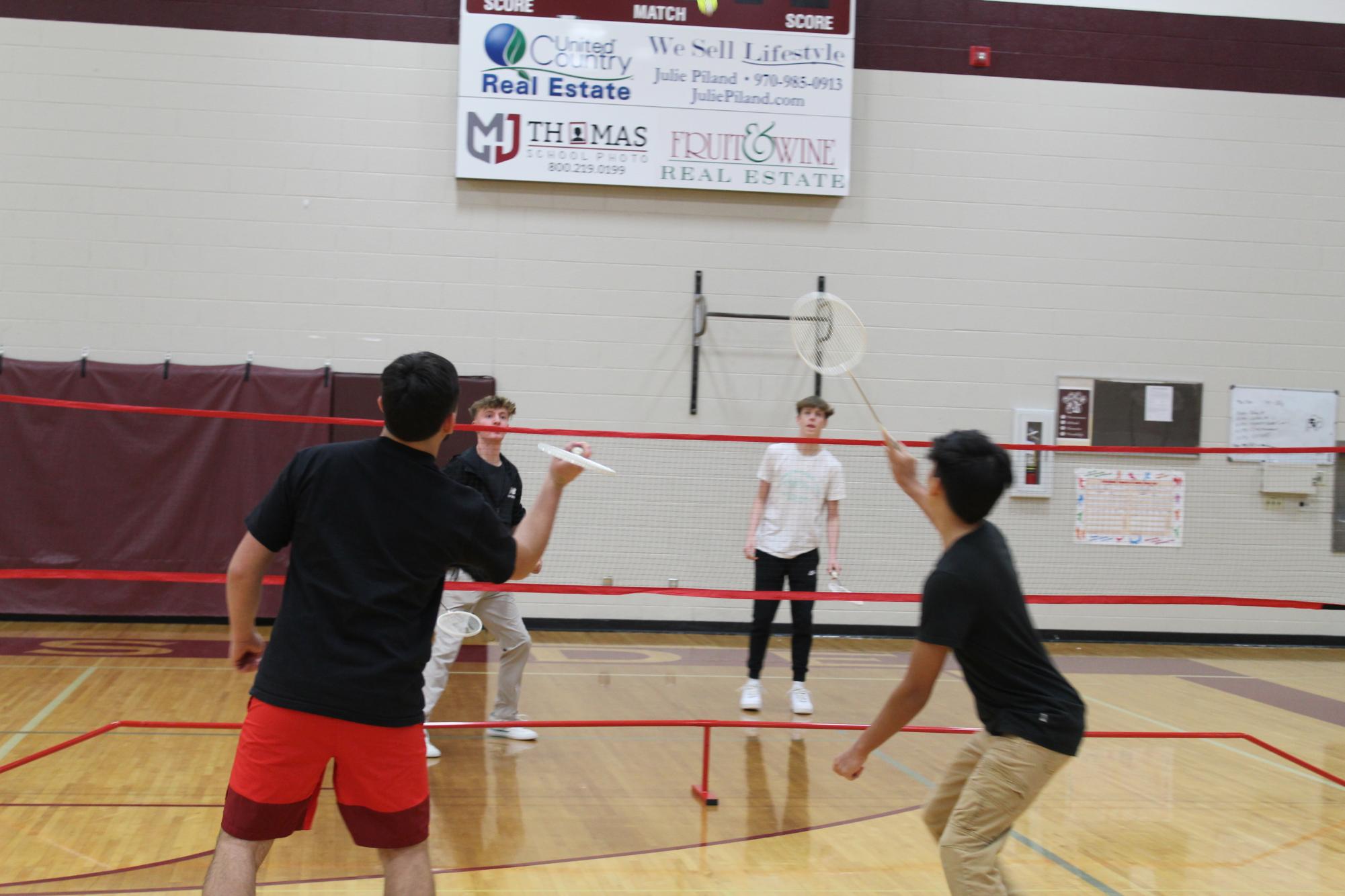 Participants competing in badminton games
