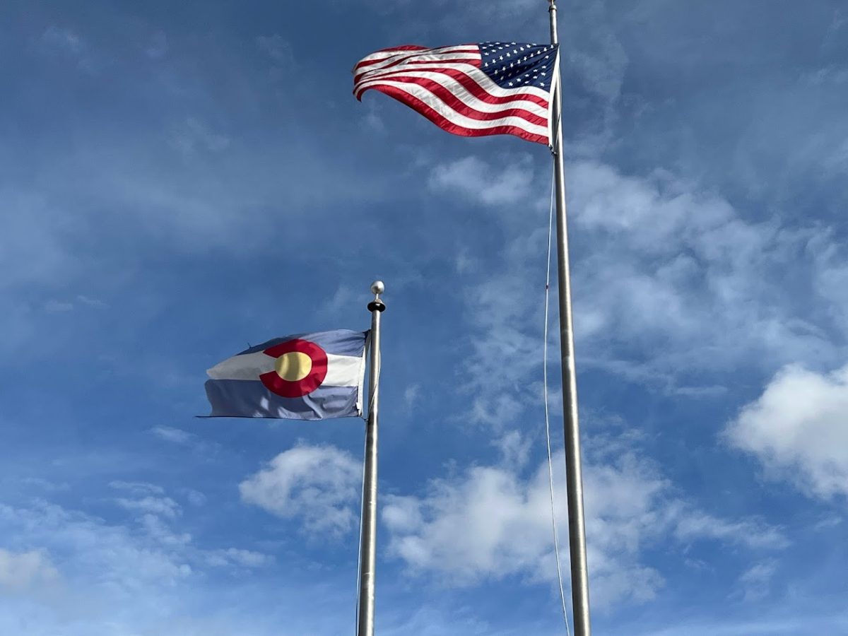 The CO and us Flag in the wind Together