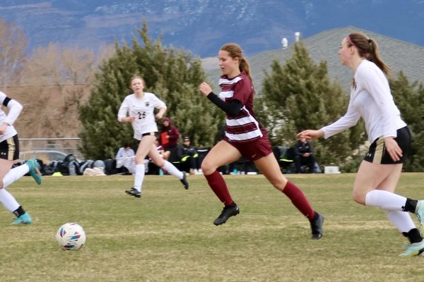 Kate Fricke bringing the ball down the field. During a game against Battle Mountain
Provided by: Holly Wing 

