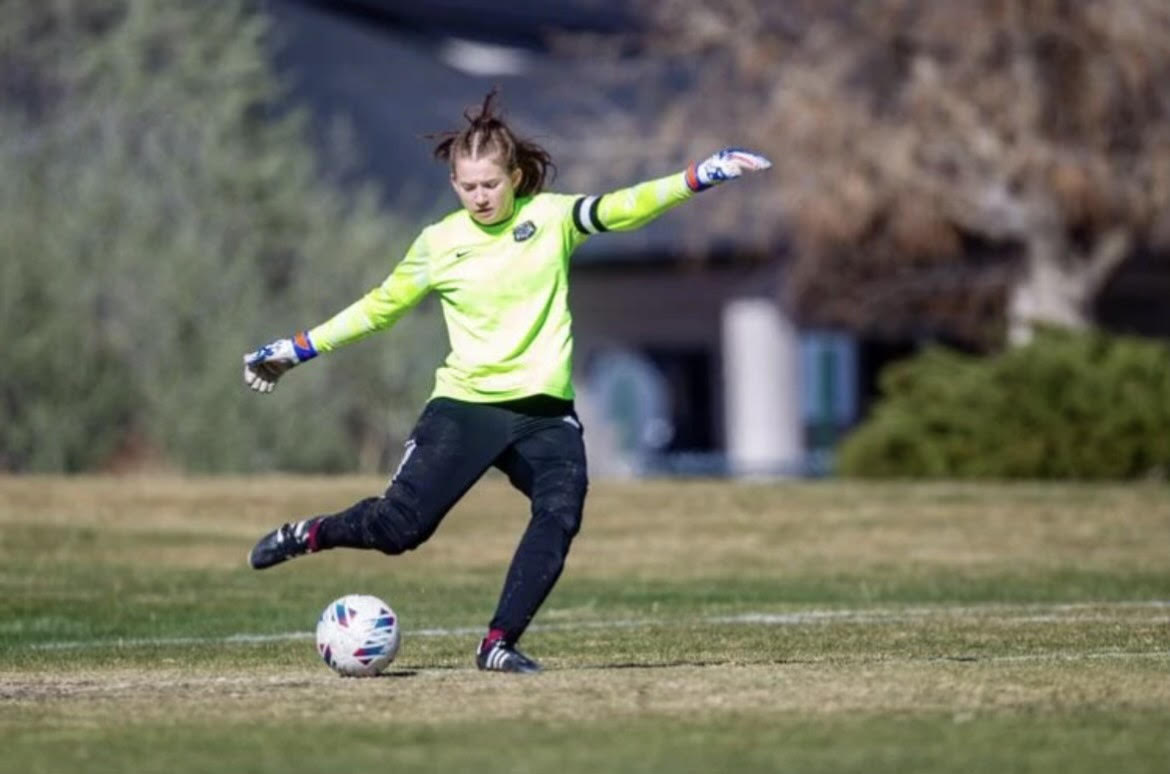 Brenae Snover, Varsity girls soccer goalie, going in for a kick. Photo provided by Brenae Snover. 