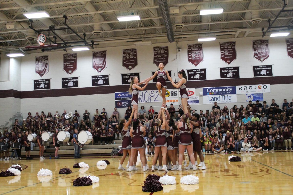 Cheer team performing at assembly during homecoming week. Photo provided by: Mallory Brownell.