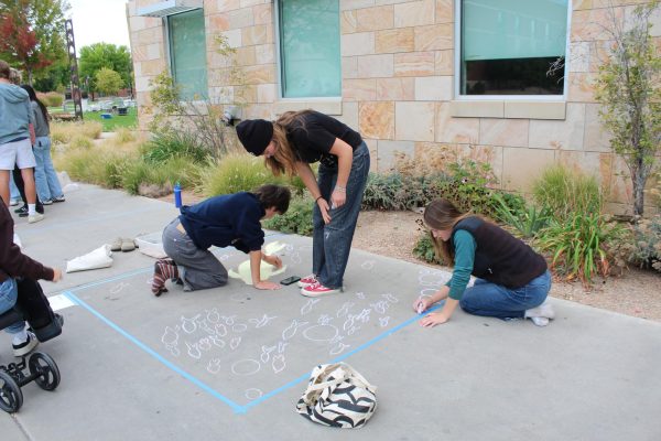 Juniors Ian Shiao, Annika Fitzgerald and Claire Powell working on the first stages of their class's chalk art. 