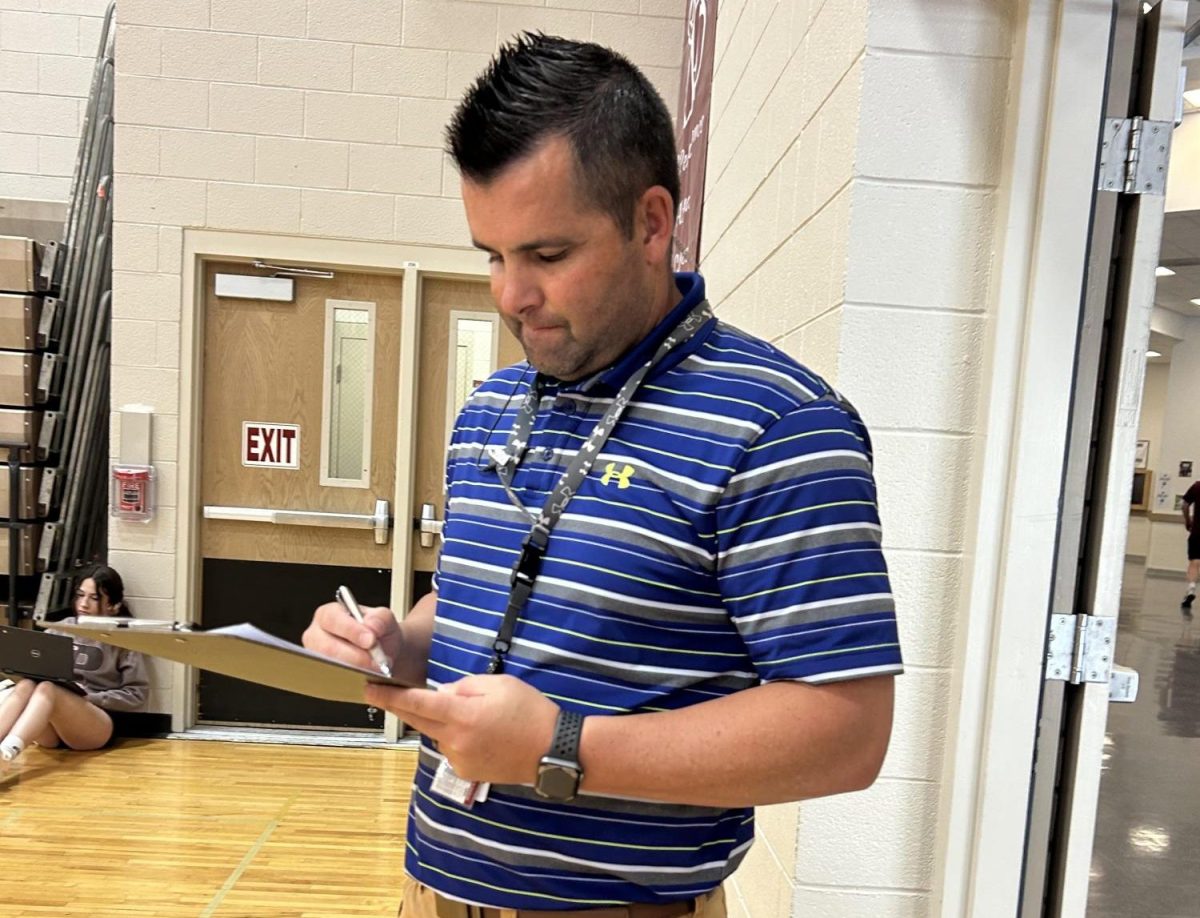 Mr. Howard (Dean of Students) checking in kids for Campus during lunch. Photo by Brielle Sorensen. 