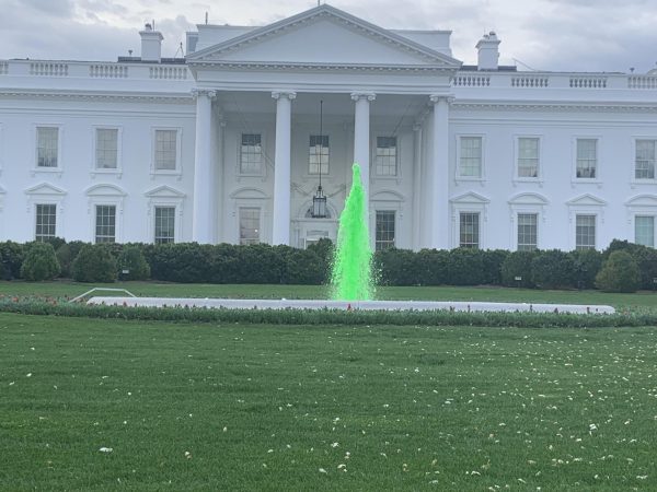 The White House, Washington D.C. with the fountain, green for Saint Patrick's day, in front.