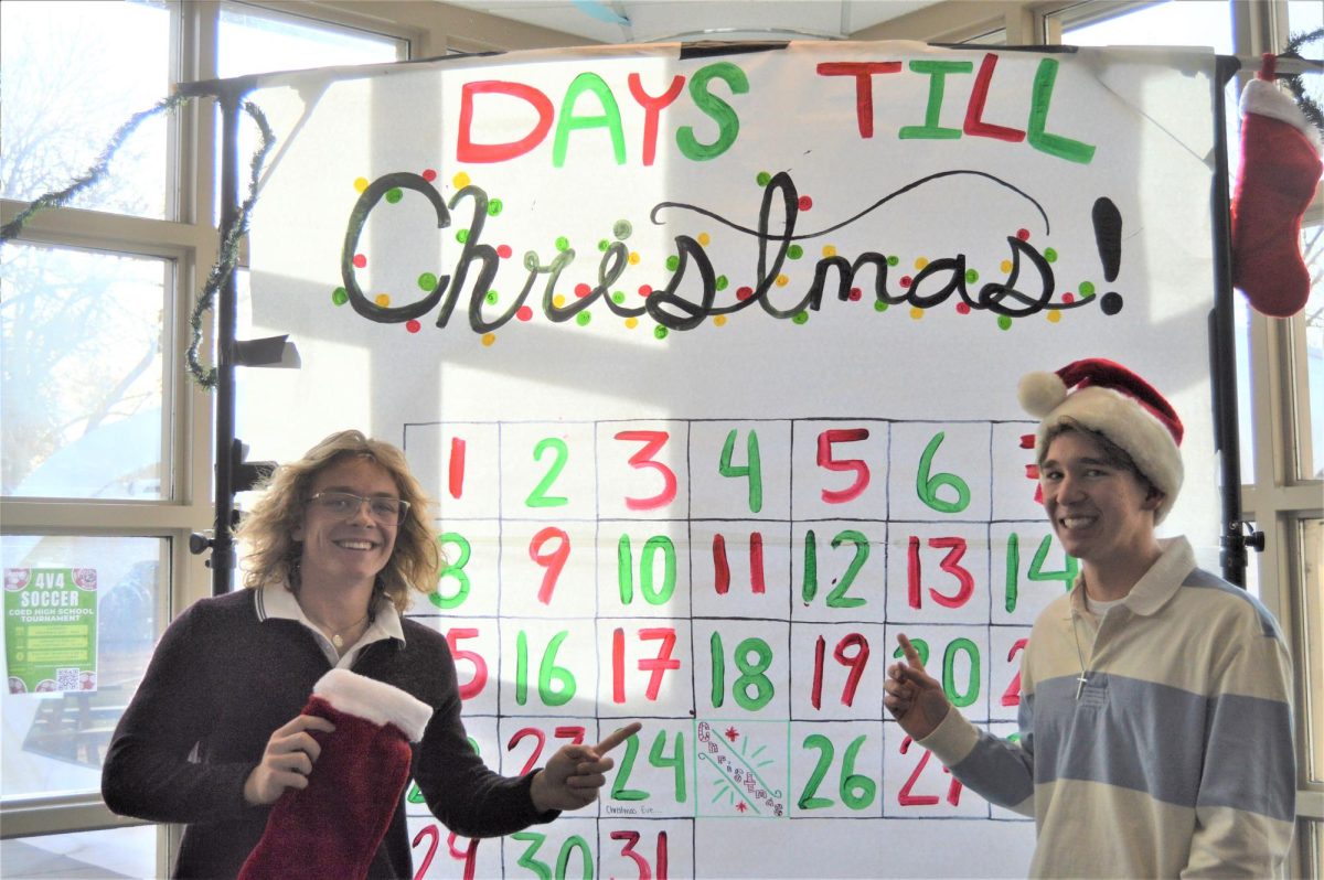 Senior Andrew Kirschenmann and Junior Jojo Kirschenmann posing with the 12 Days of Christmas calendar.