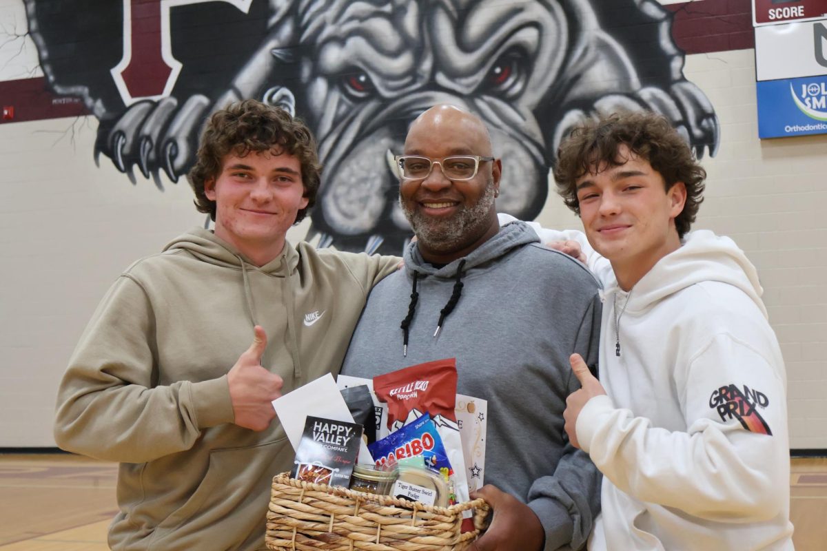 Tristan Brinton (Left) Coach D (Middle) Adyn Cassity (Right).
Photo Taken: Ciera Colson