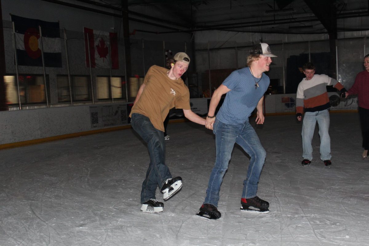 Junior Cade Carter hauling his friend on the ice.