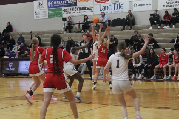 Lyla Lancaster passing the ball down low to Mady Bavor.  