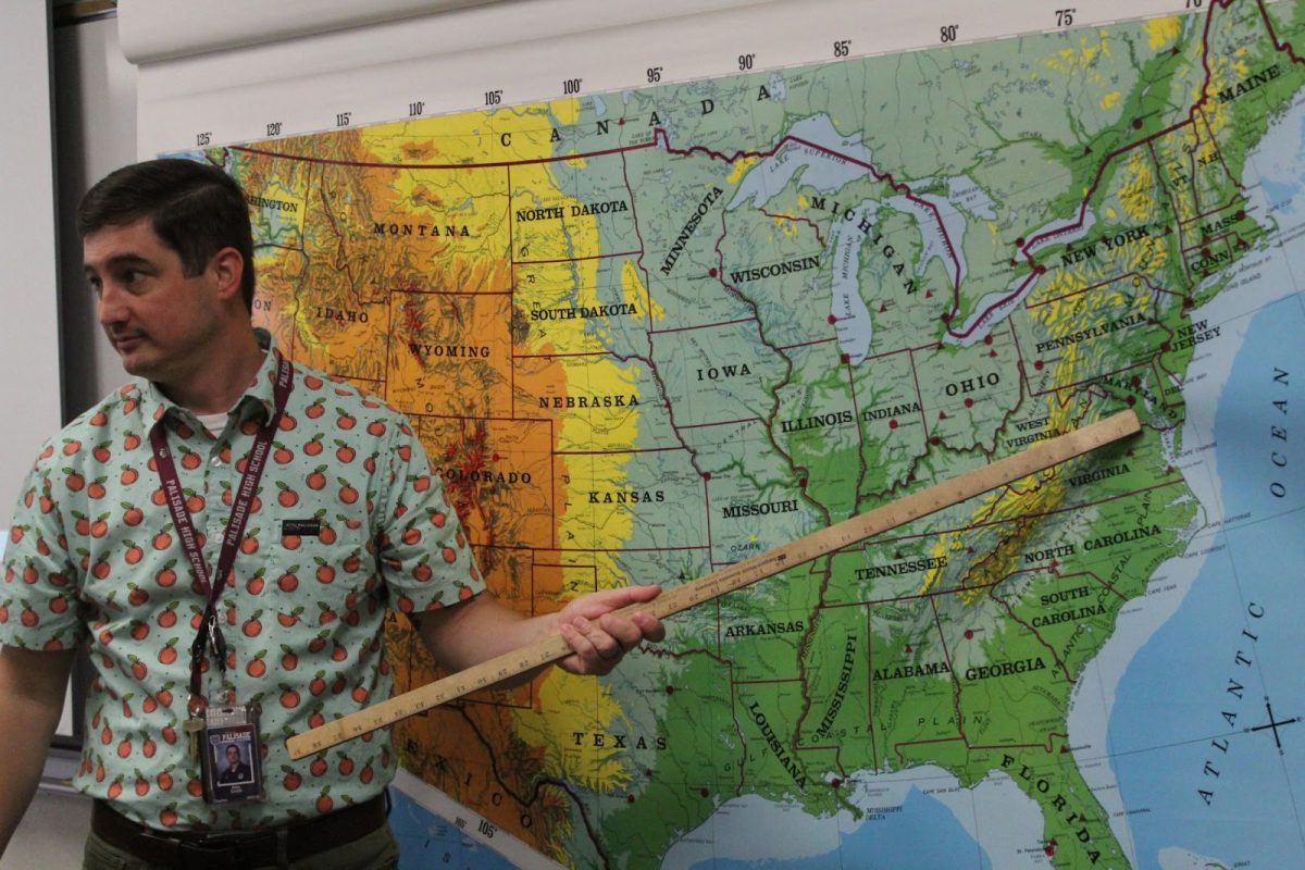 Mr. Smith points to Washington D.C. on a U.S. map.