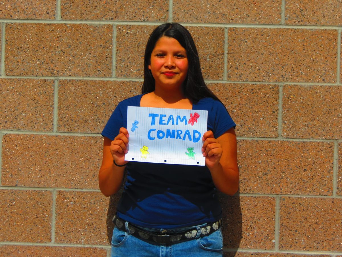 Palisade student holding up team conrad sign