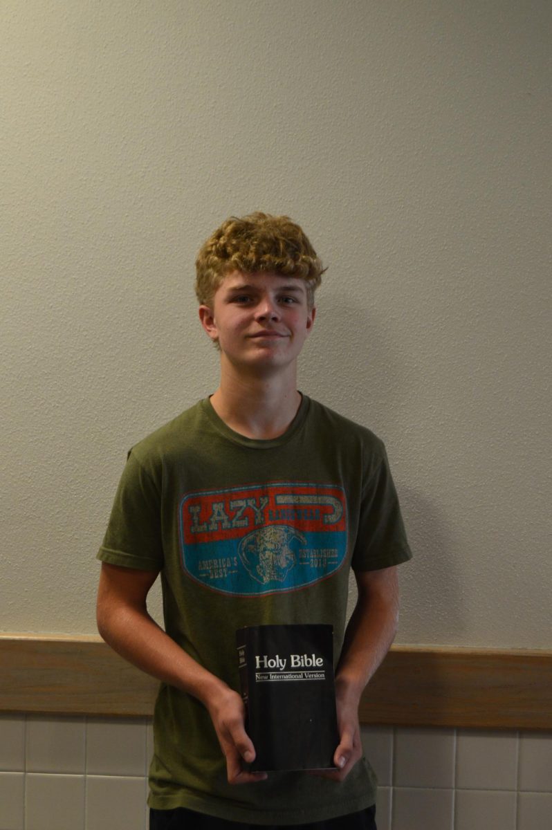 Jackson Morby holding a Bible 