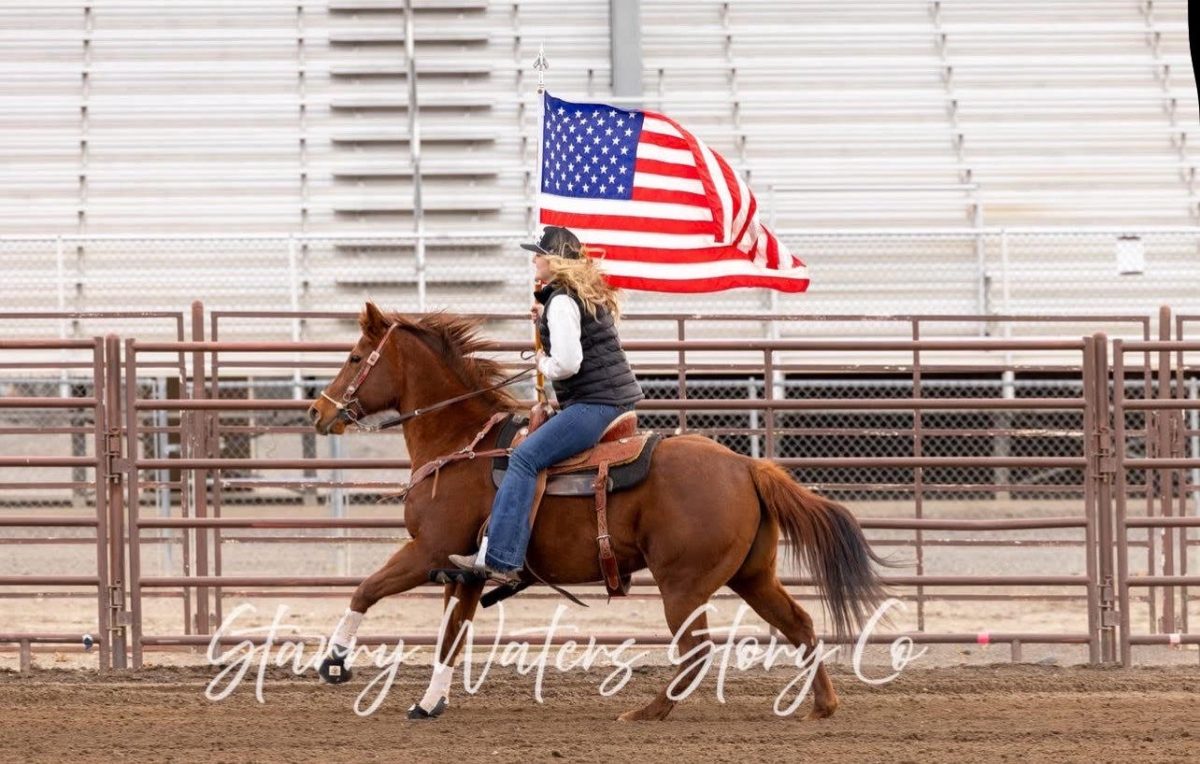 Photo of Macie Brown carrying the American flag on her horse. Photo provided by Macie Brown.
