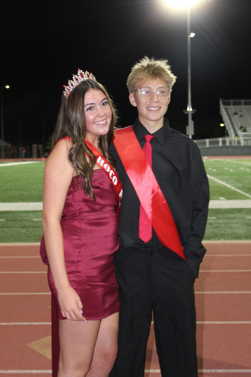 Juniors Alexis Lopez and Talon Despain getting there photo taken after the half time show.