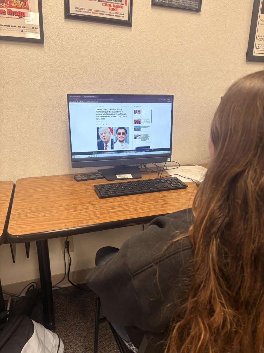 Zoey Ramsey reading the most recent updates on the Bad Bunny halftime show.