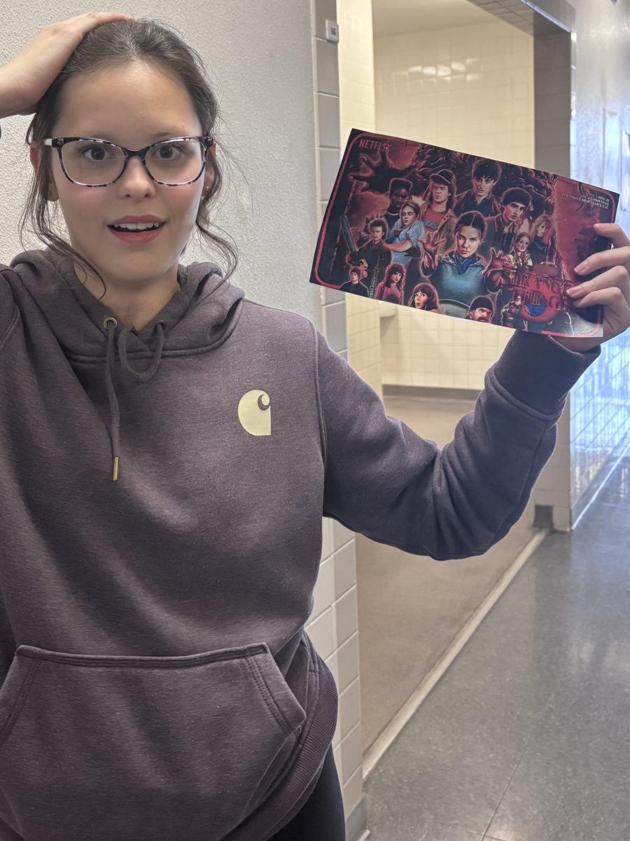 Freshman Ziva Howell, Fan of Stranger Things holding Season five poster.