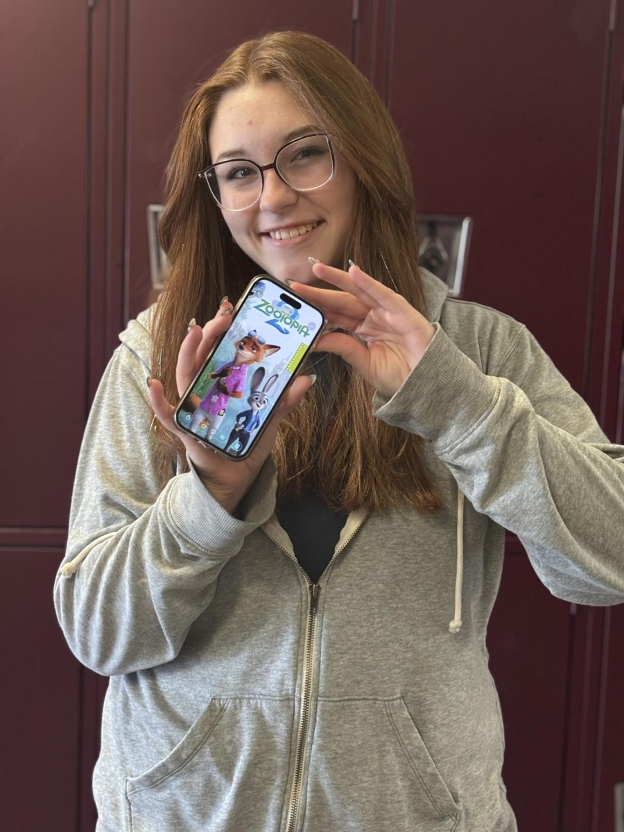 Lily Magnabosco Freshman at PHS holding photo for Zootopia 2 poster.