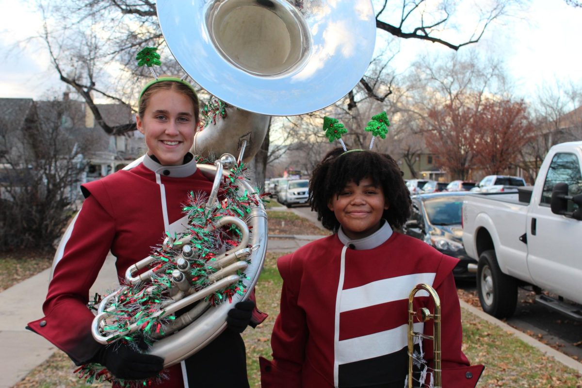 Photo of Palisade High Schools marching band members Wood, and Anthony, along with PHS Cheer team, and Spike and Spikette PHS Mascots, at the Parade of Lights on Saturday, December 6th.