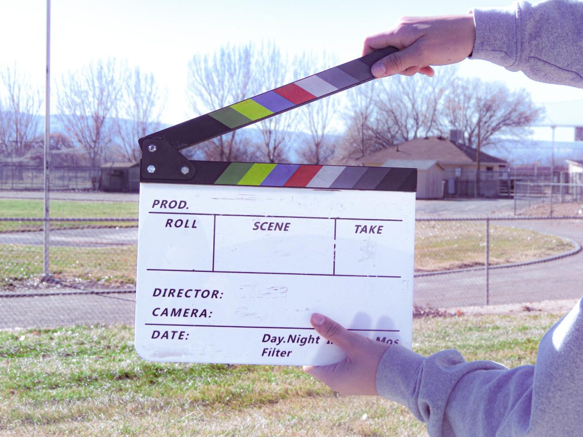 Palisade student  Kaedyn Nielsen holding up an action movie board