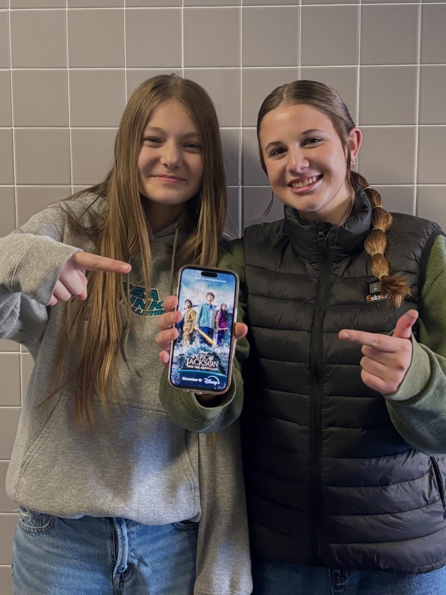 Two Palisade Freshman Excited for Season Two of Percy Jackson. Holding up the new poster for the season!