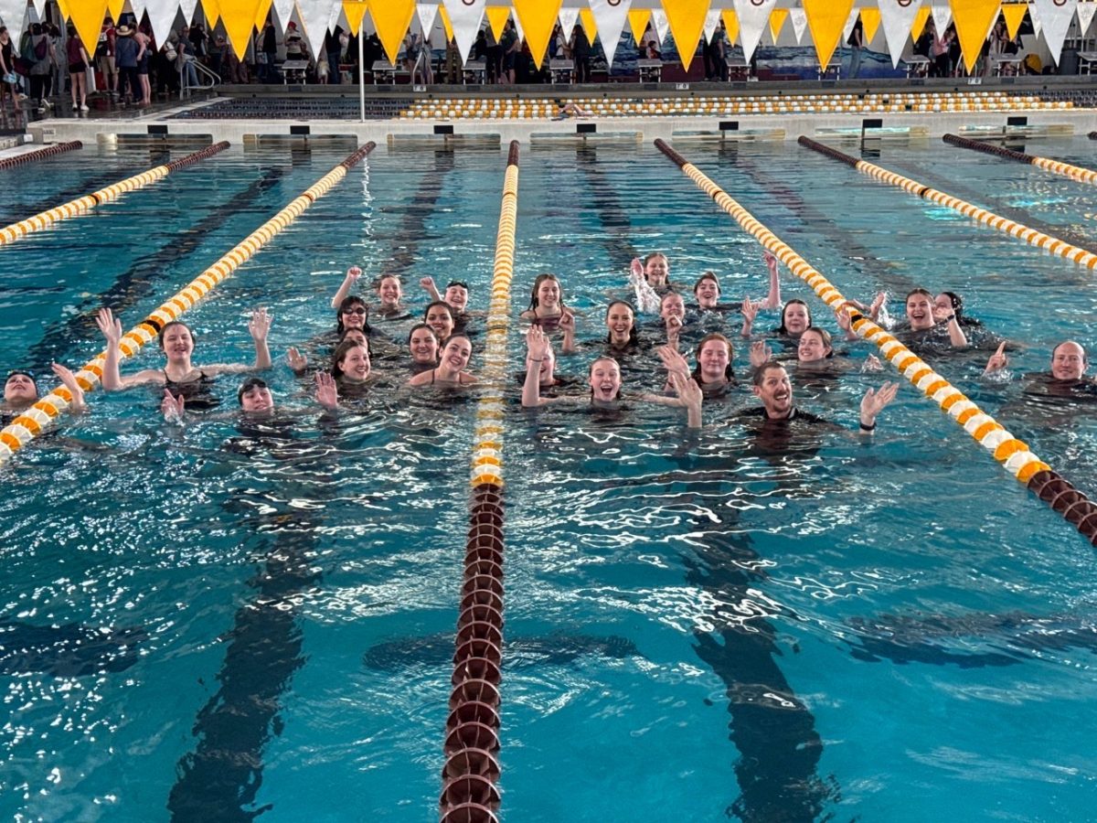 Photo of Girls Swimming team gathered together in the pool after the yearly swim conference.