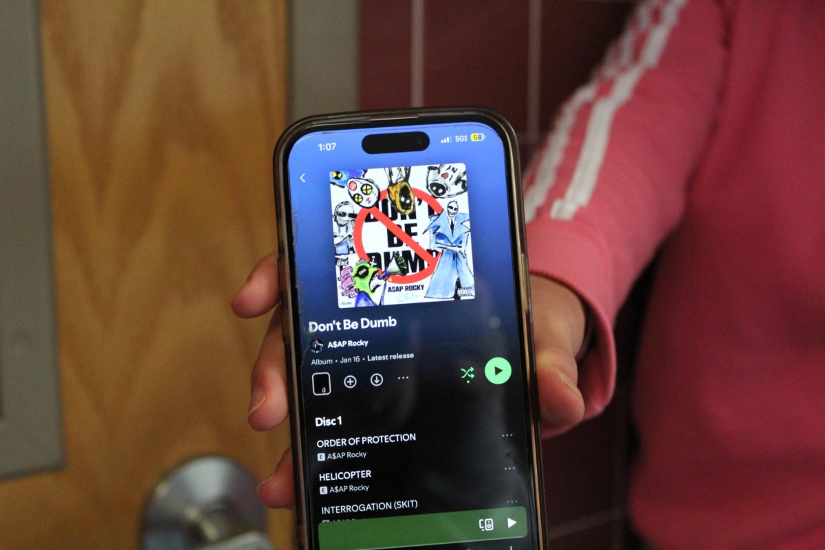 Adaly Martinez holding phone with album