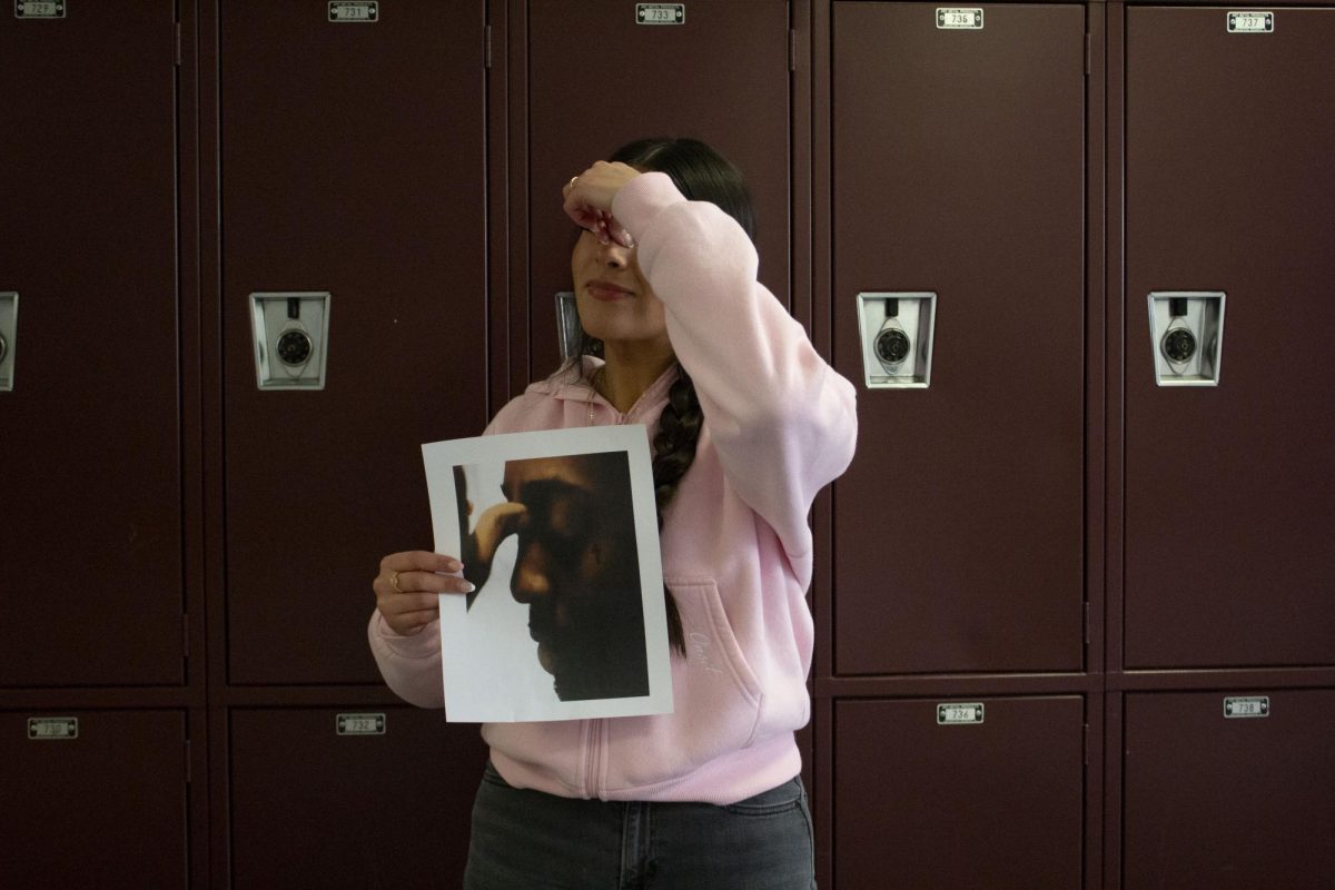 Adaly Martinez holding image of new album.