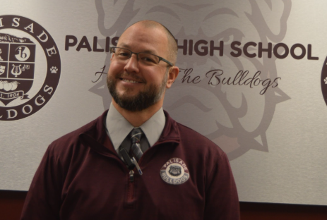 Mr. Borgemann, the assistant principal at Palisade High School, is posing for a photo.