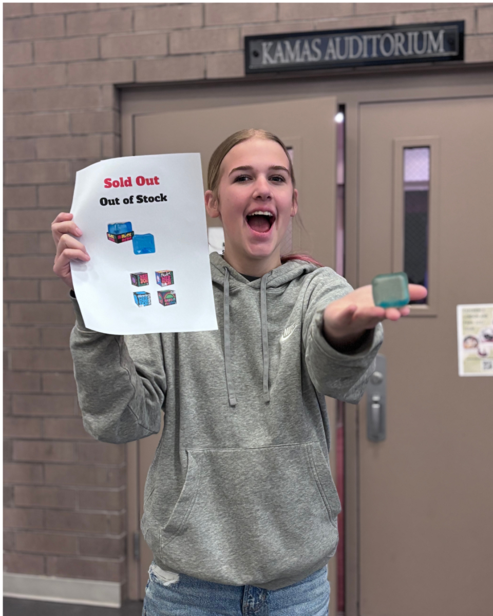 Alexia Stratman fan of NeehDohs holding up Neehdoh small Ice cube. And sold out sign.
