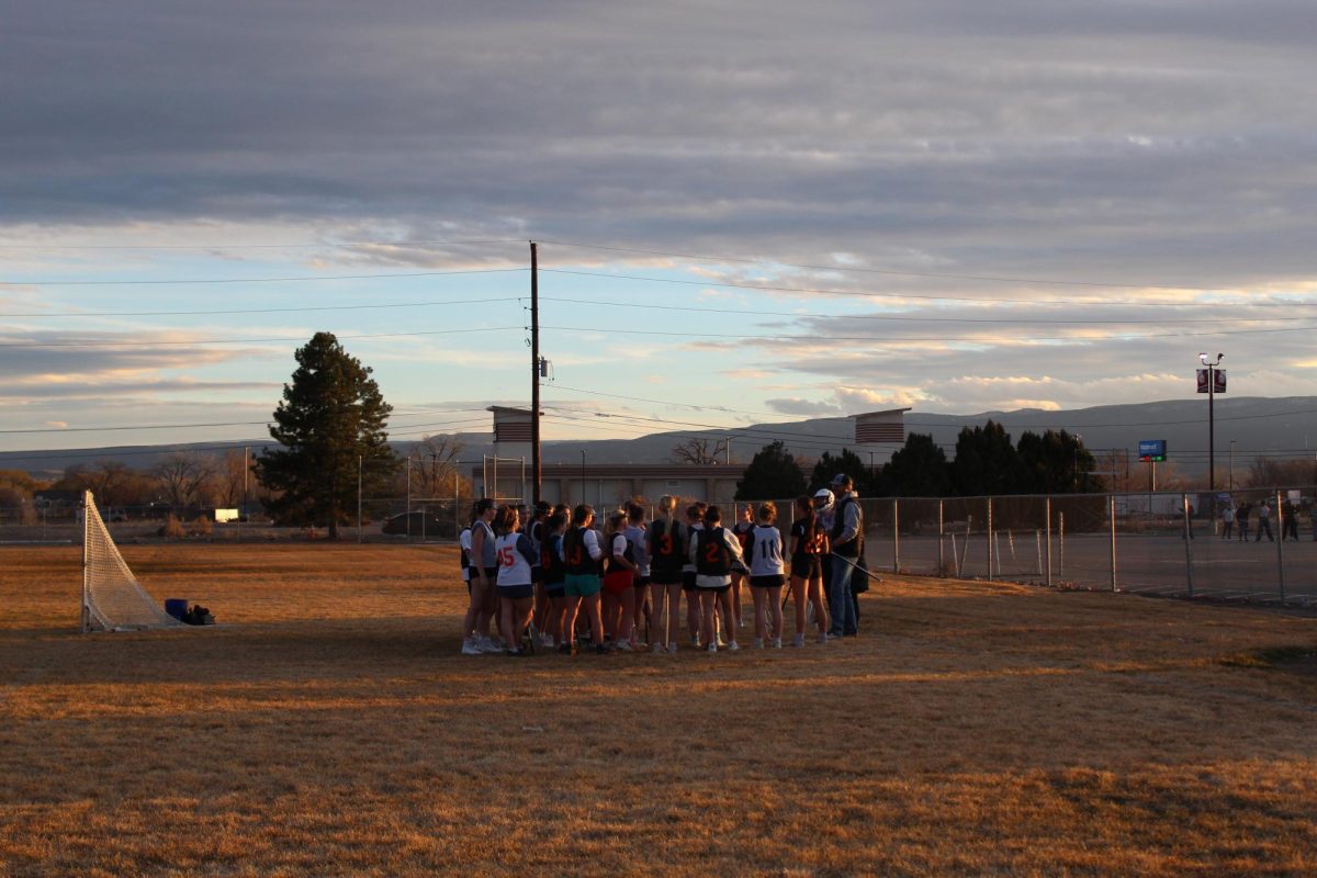 Girls Lacrosse practicing on central football field