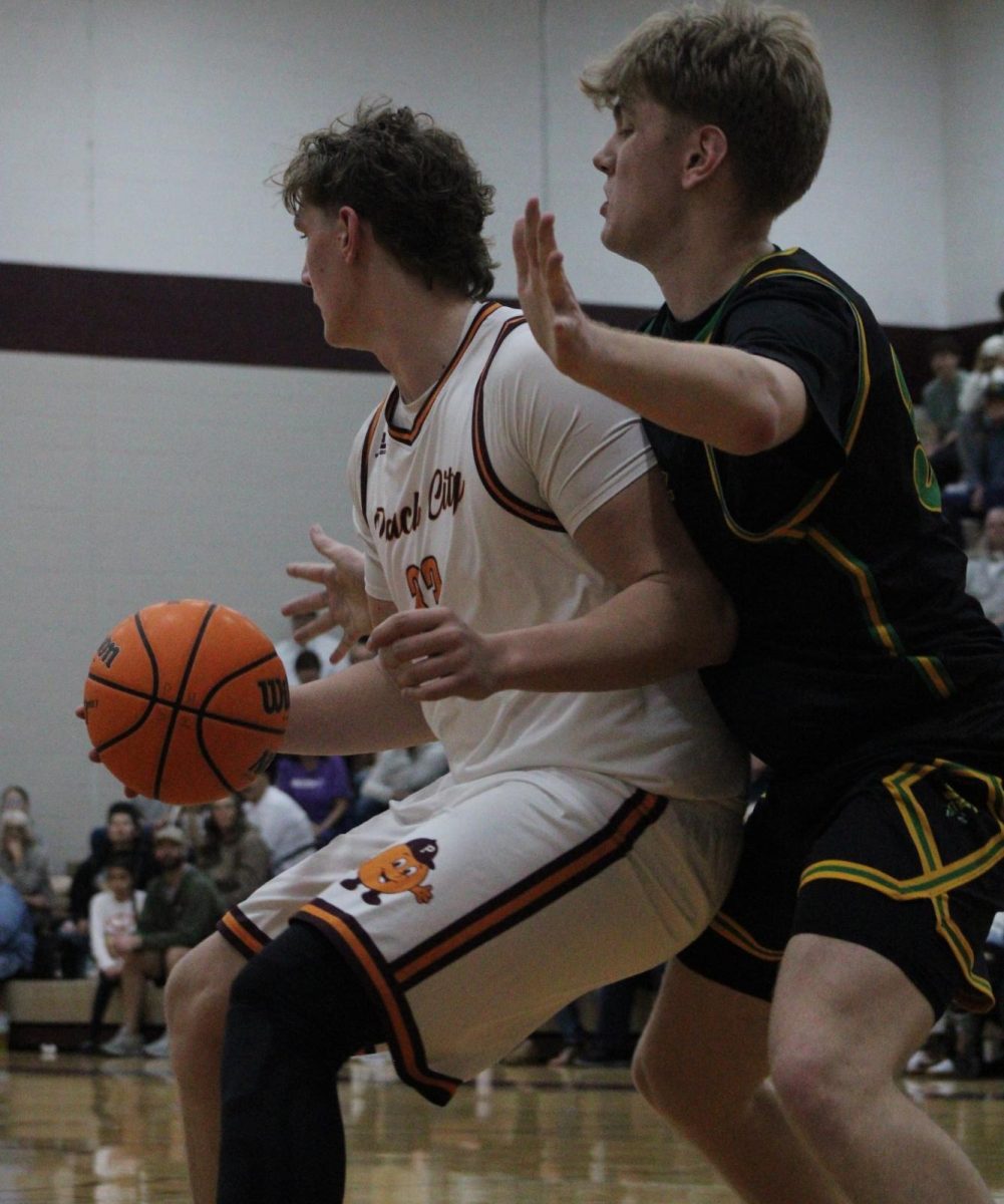 Junior Todd Nordenson holding the ball with a defender on his back