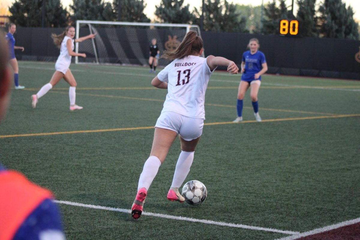 Number 13, Carlie Rhoden taking the ball to the net to score while looking for someone that's open for help.
