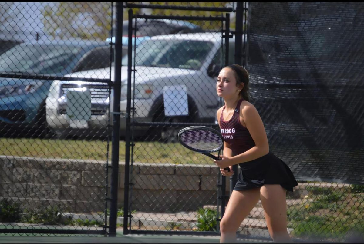 Senior Haley Ammons playing in a tennis match at the 2 singles position.
