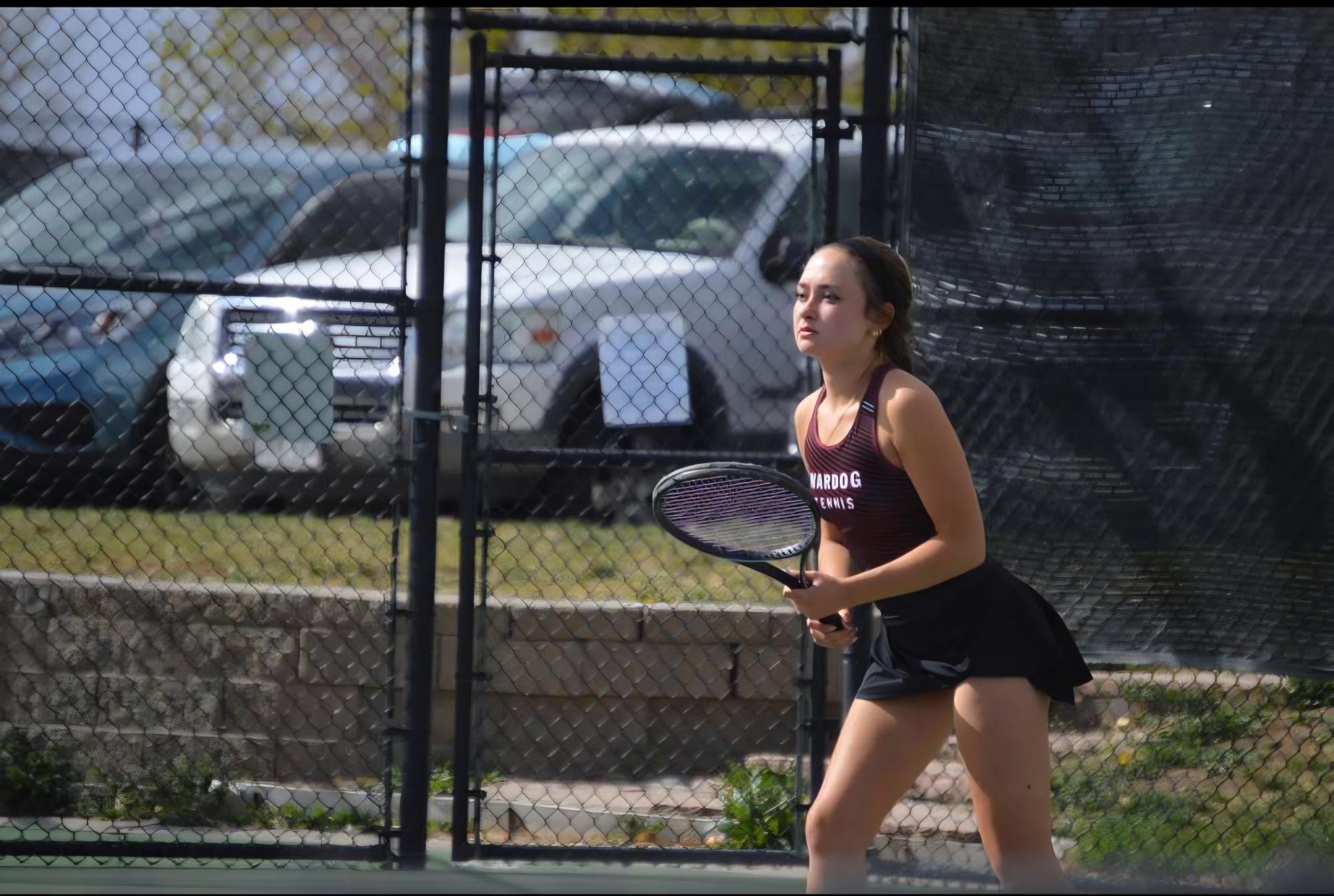 Senior Haley Ammons playing in a tennis match at the 2 singles position.