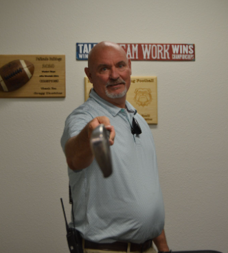 Mr. Hawkins holding up his golf club 